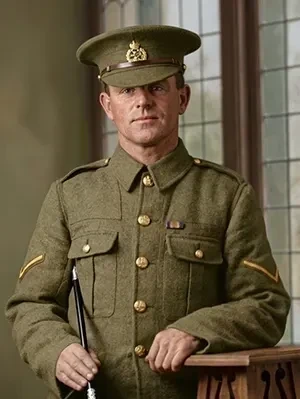 Studio portrait of Corporal Frank Finden posing in full military uniform.